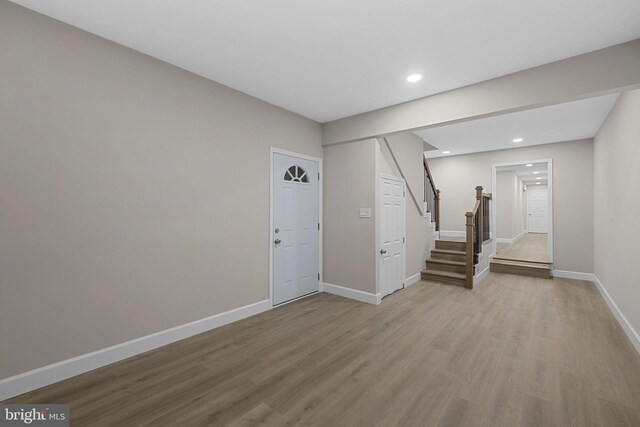 basement with hardwood / wood-style floors