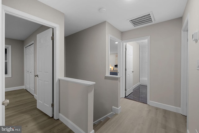 hallway with light hardwood / wood-style flooring