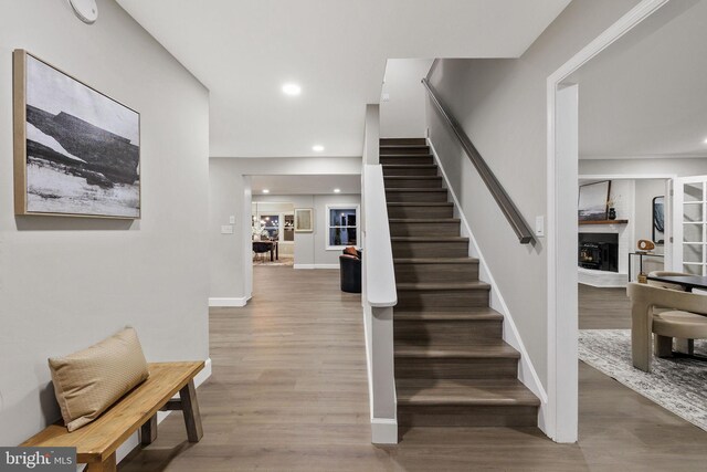 stairs with hardwood / wood-style floors