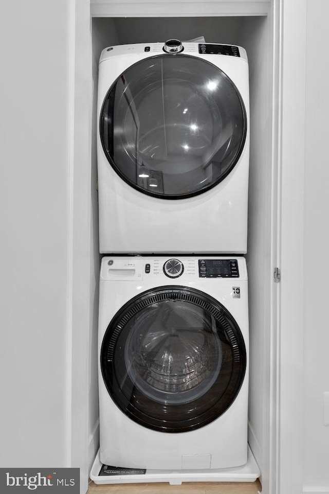 laundry area with stacked washer and dryer