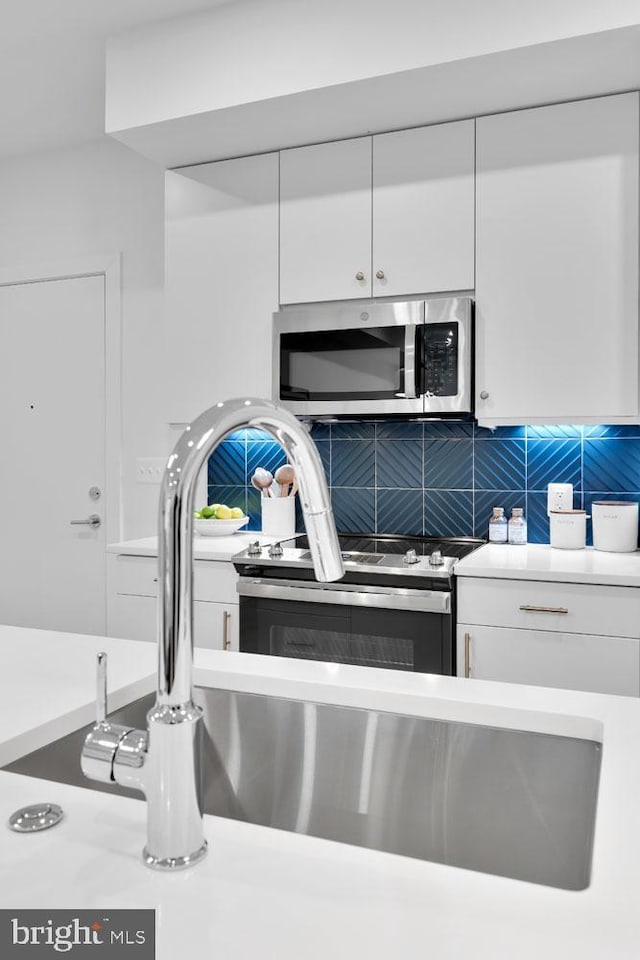 interior details with white cabinetry and backsplash