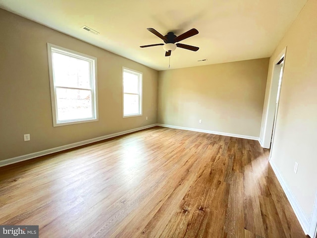 empty room with light wood-type flooring and ceiling fan