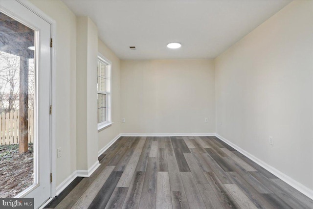 unfurnished room with dark hardwood / wood-style floors