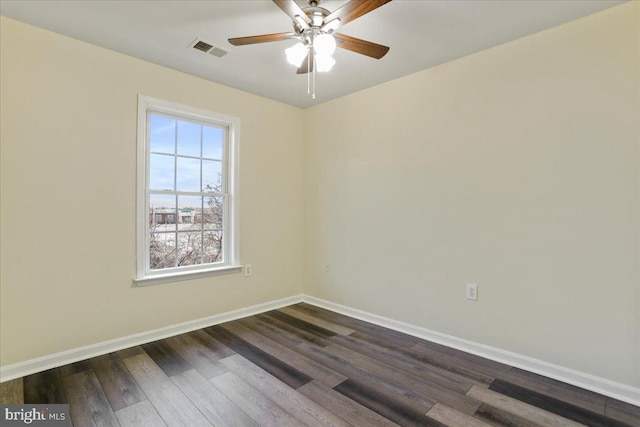 spare room with dark hardwood / wood-style flooring and ceiling fan