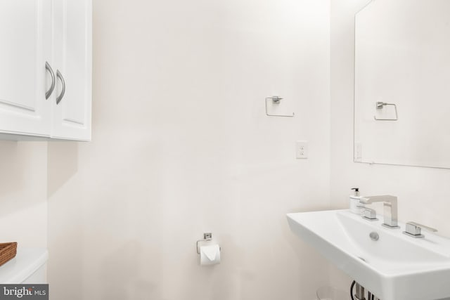 bathroom featuring sink and toilet