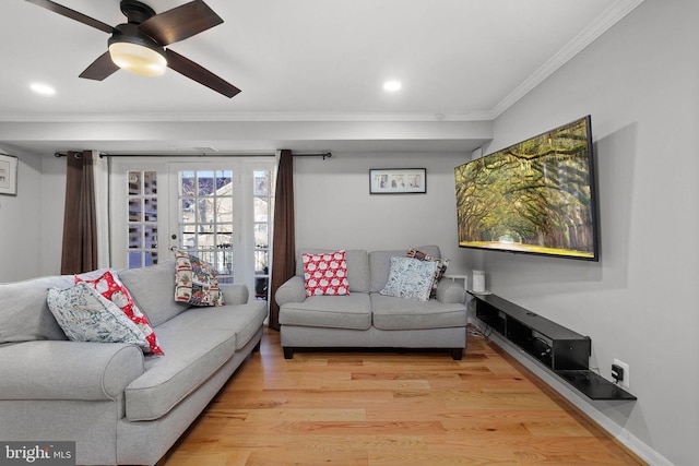 living room with ceiling fan, hardwood / wood-style floors, french doors, and ornamental molding