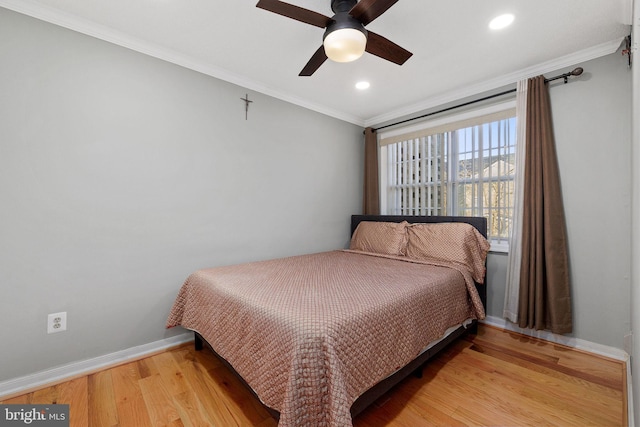 bedroom featuring ceiling fan, ornamental molding, and hardwood / wood-style flooring