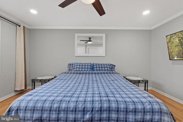 bedroom with hardwood / wood-style flooring, ceiling fan, and ornamental molding