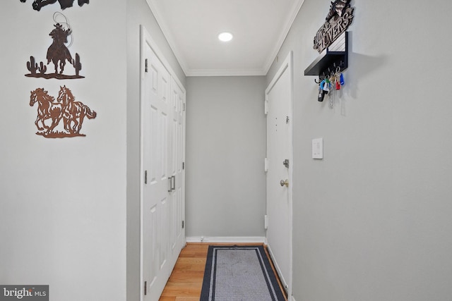 corridor featuring wood-type flooring and ornamental molding