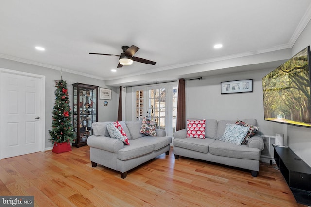 living room featuring french doors, light hardwood / wood-style flooring, ceiling fan, and ornamental molding