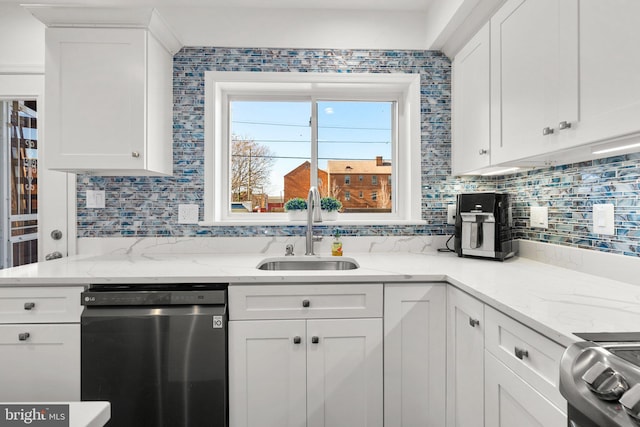 kitchen with dishwasher, white cabinets, and sink