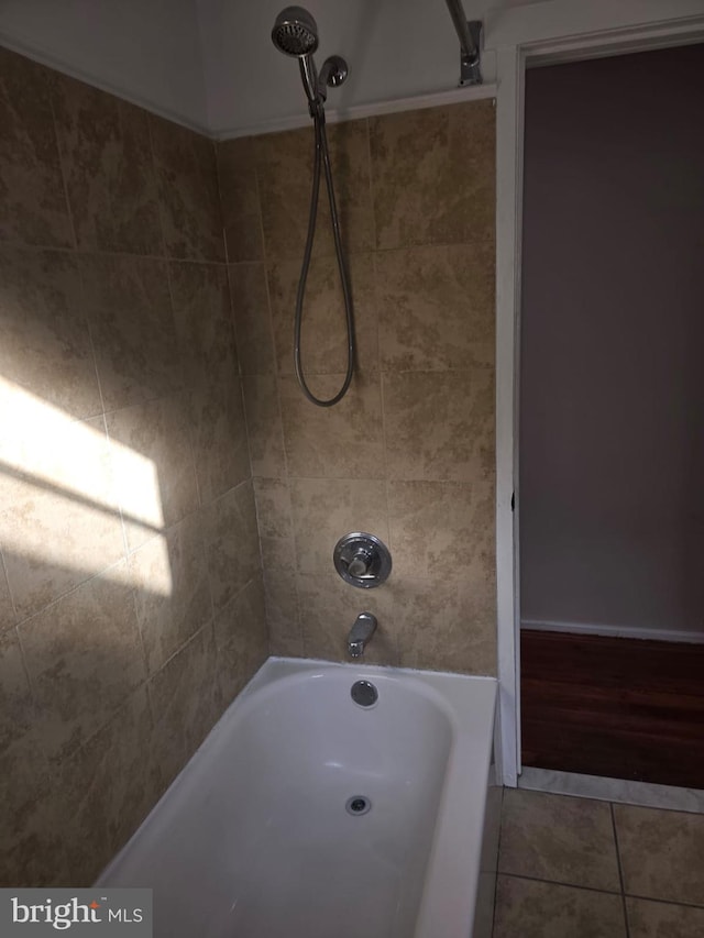 bathroom with tile patterned flooring and tiled shower / bath