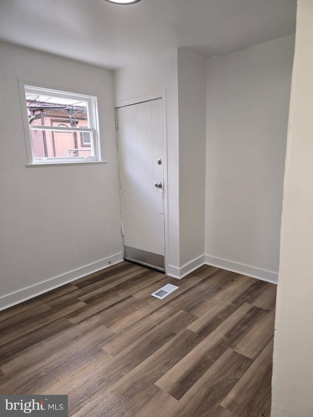 spare room featuring dark wood-type flooring