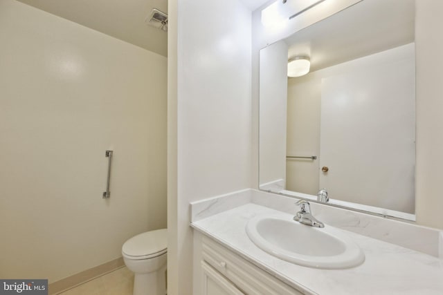 bathroom featuring toilet, tile patterned flooring, vanity, and visible vents