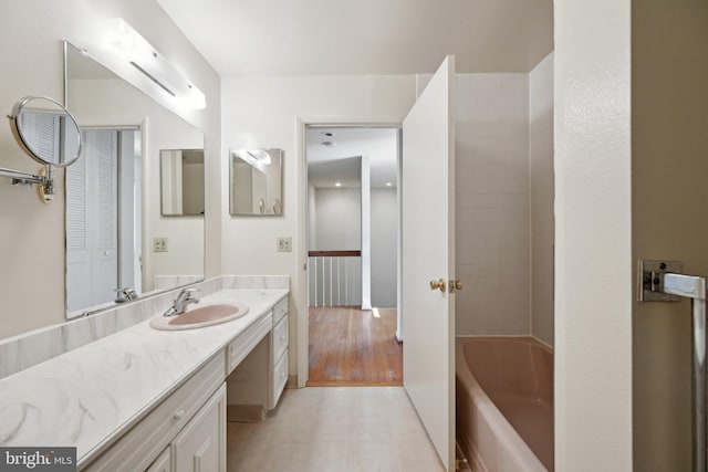 bathroom with a closet and vanity