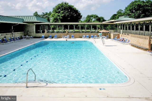 pool featuring a patio area and fence