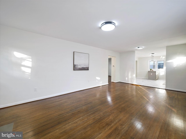 unfurnished room with dark hardwood / wood-style floors