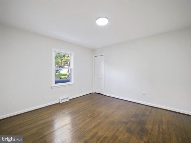 empty room with dark wood-type flooring