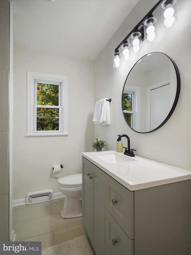 bathroom with tile patterned floors, vanity, and toilet