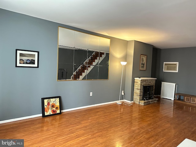 unfurnished living room featuring a fireplace and hardwood / wood-style floors