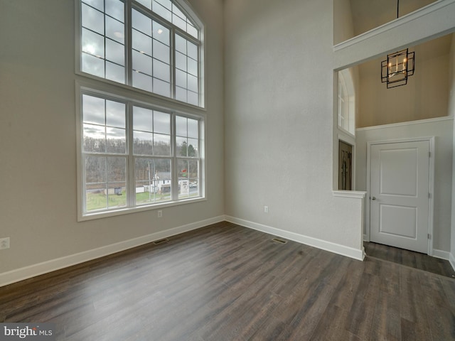 12544 Woodsboro Pike, Keymar, MD 21757 - unfurnished living room featuring a notable chandelier, dark hardwood / wood-style flooring, and a high ceiling