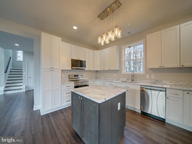 12544 Woodsboro Pike, Keymar, MD 21757 - kitchen featuring hanging light fixtures, a kitchen island, light stone counters, white cabinetry, and stainless steel appliances