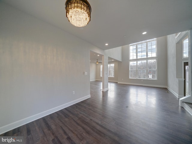 12544 Woodsboro Pike, Keymar, MD 21757 - unfurnished living room with ceiling fan with notable chandelier and dark hardwood / wood-style floors