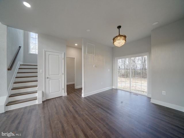 12544 Woodsboro Pike, Keymar, MD 21757 - unfurnished living room with a notable chandelier, plenty of natural light, and dark hardwood / wood-style flooring