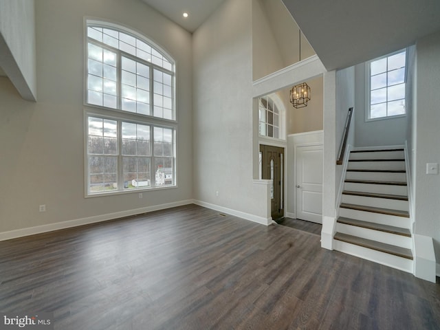 12544 Woodsboro Pike, Keymar, MD 21757 - unfurnished living room featuring a high ceiling, an inviting chandelier, and dark wood-type flooring
