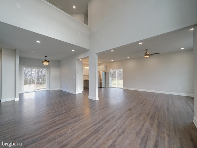 12544 Woodsboro Pike, Keymar, MD 21757 - unfurnished living room featuring ceiling fan, dark wood-type flooring, and a high ceiling