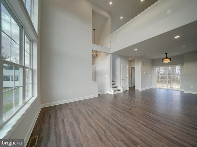 12544 Woodsboro Pike, Keymar, MD 21757 - unfurnished living room with dark hardwood / wood-style flooring, a towering ceiling, and an inviting chandelier