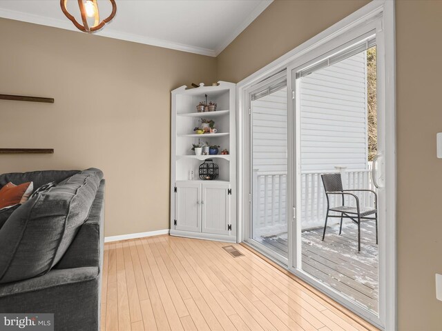 interior space with light hardwood / wood-style floors and crown molding