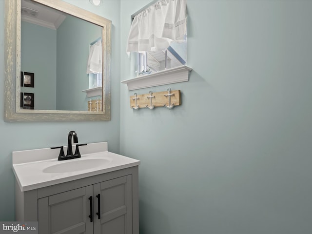 bathroom featuring vanity and ornamental molding