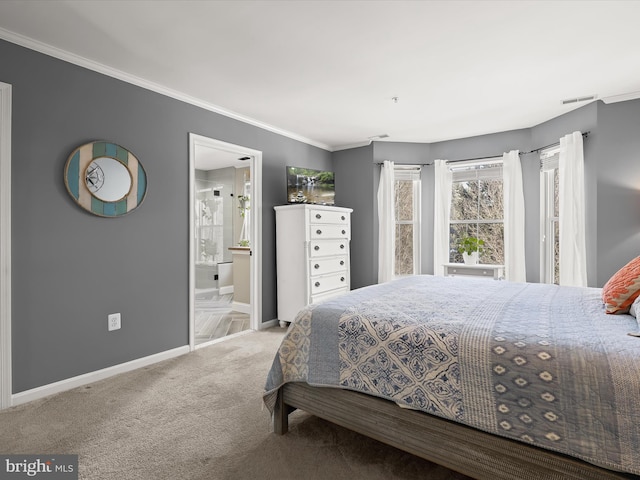 bedroom with carpet flooring, ensuite bath, and crown molding