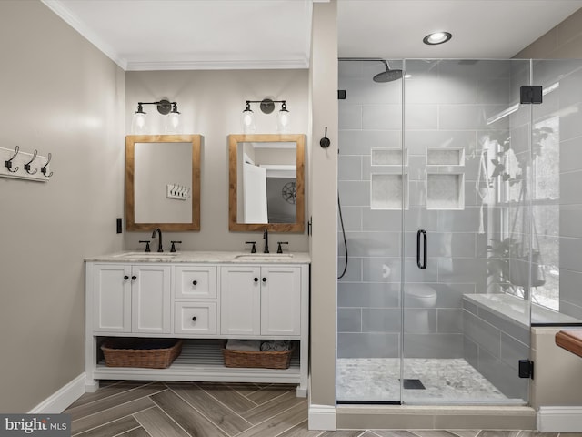 bathroom featuring vanity, a shower with door, parquet floors, and ornamental molding