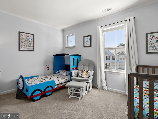 bedroom with light carpet, a crib, and ornamental molding