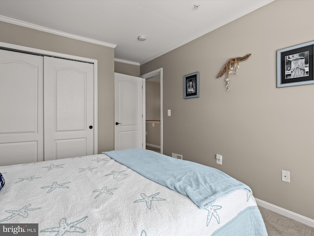 carpeted bedroom with a closet and ornamental molding