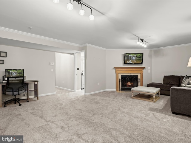 carpeted living room with ornamental molding and rail lighting