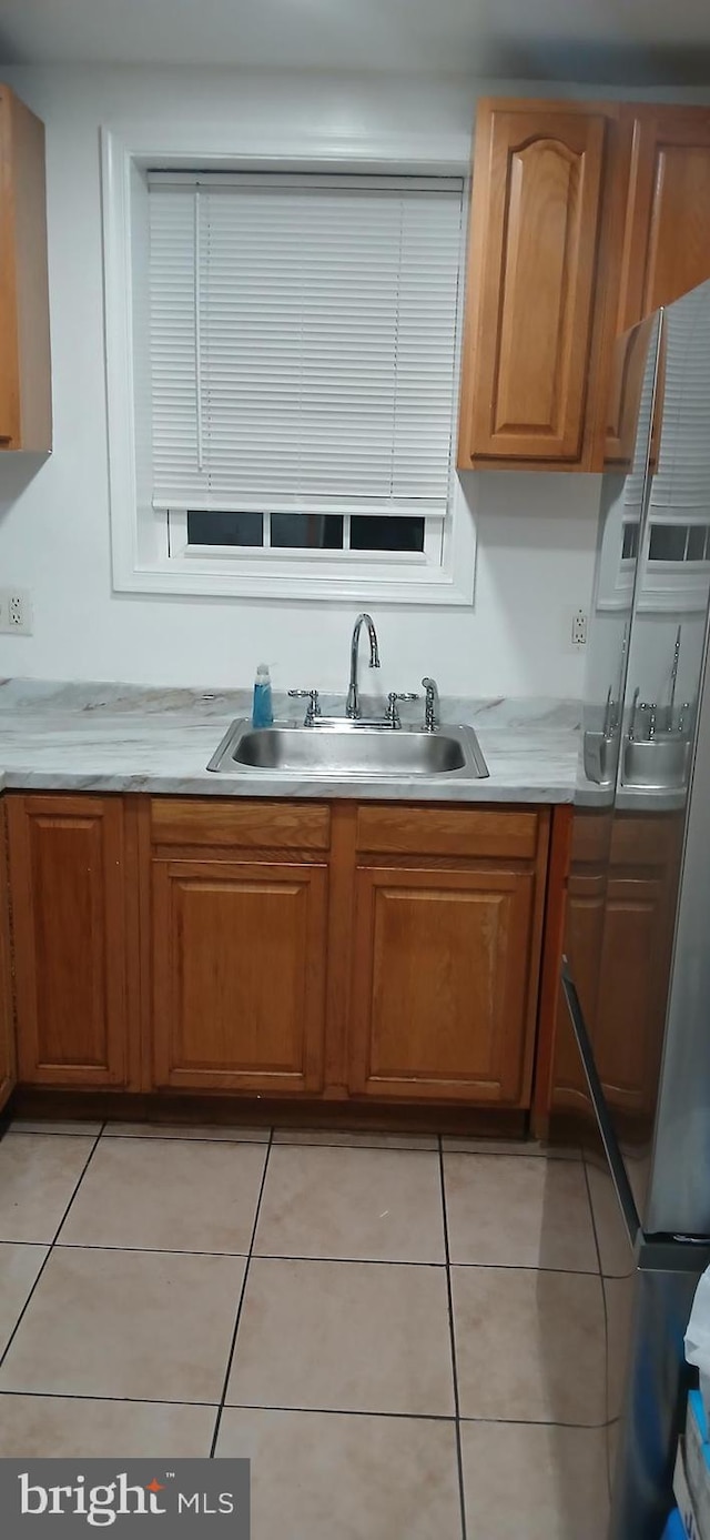 kitchen featuring sink and light tile patterned floors