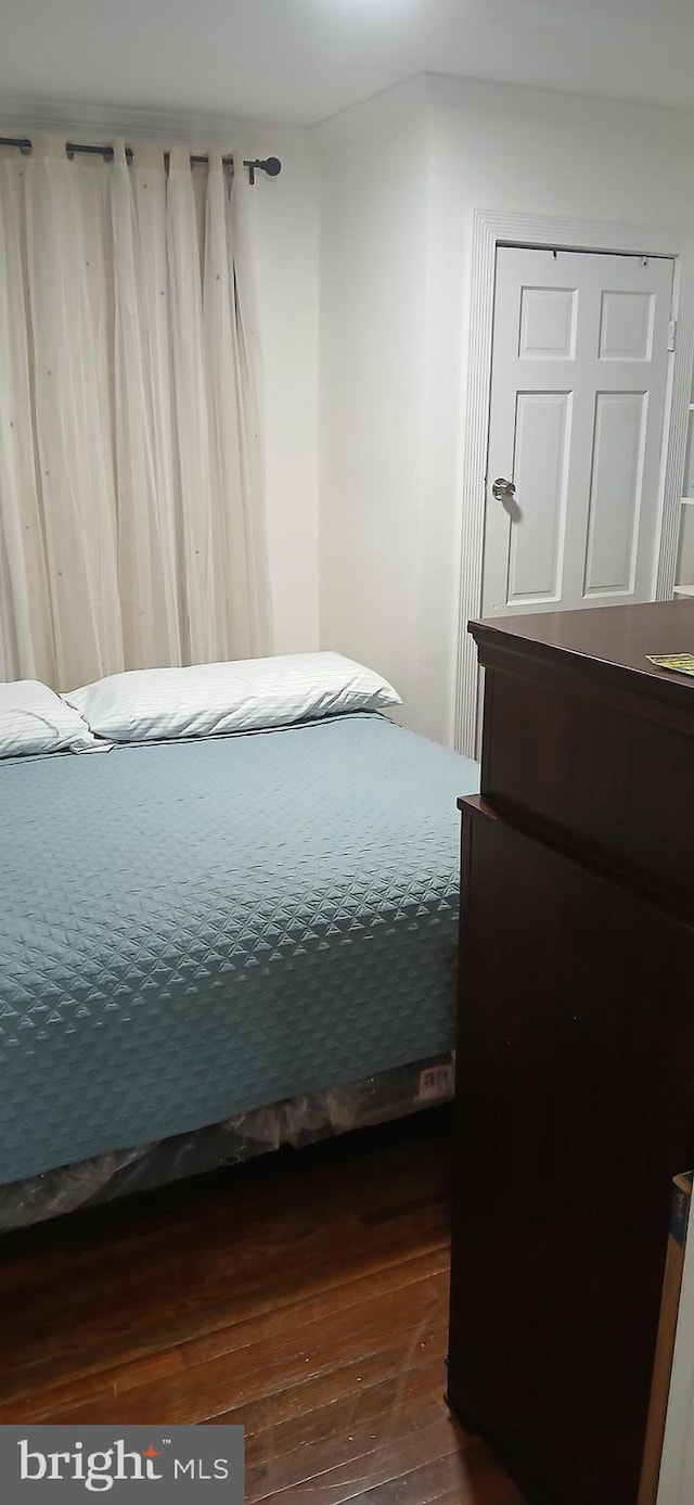 bedroom with hardwood / wood-style floors