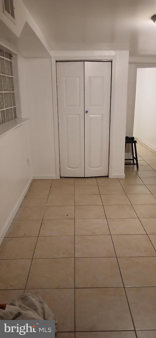 unfurnished bedroom featuring tile patterned floors and a closet