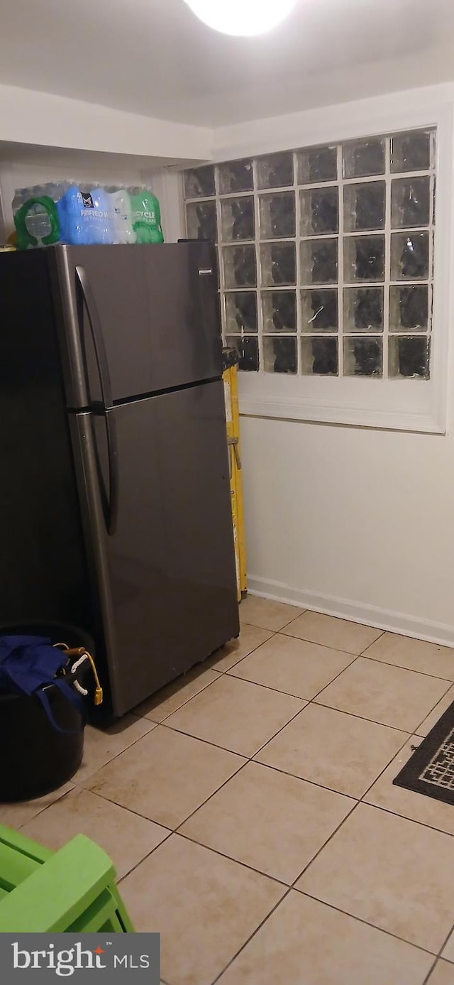 kitchen featuring tile patterned floors and stainless steel fridge