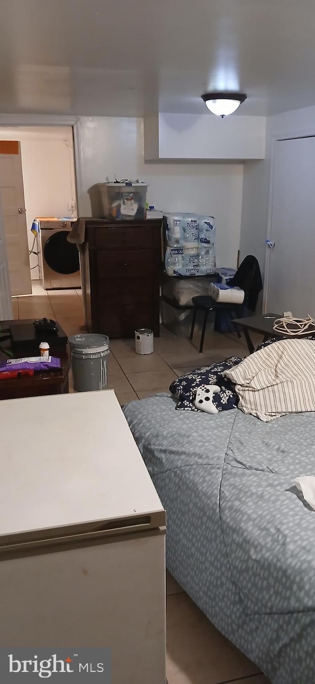 tiled bedroom with washer / clothes dryer