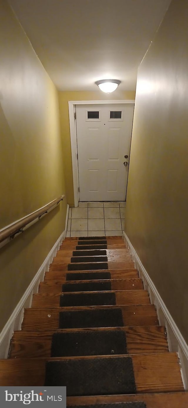 staircase featuring tile patterned floors