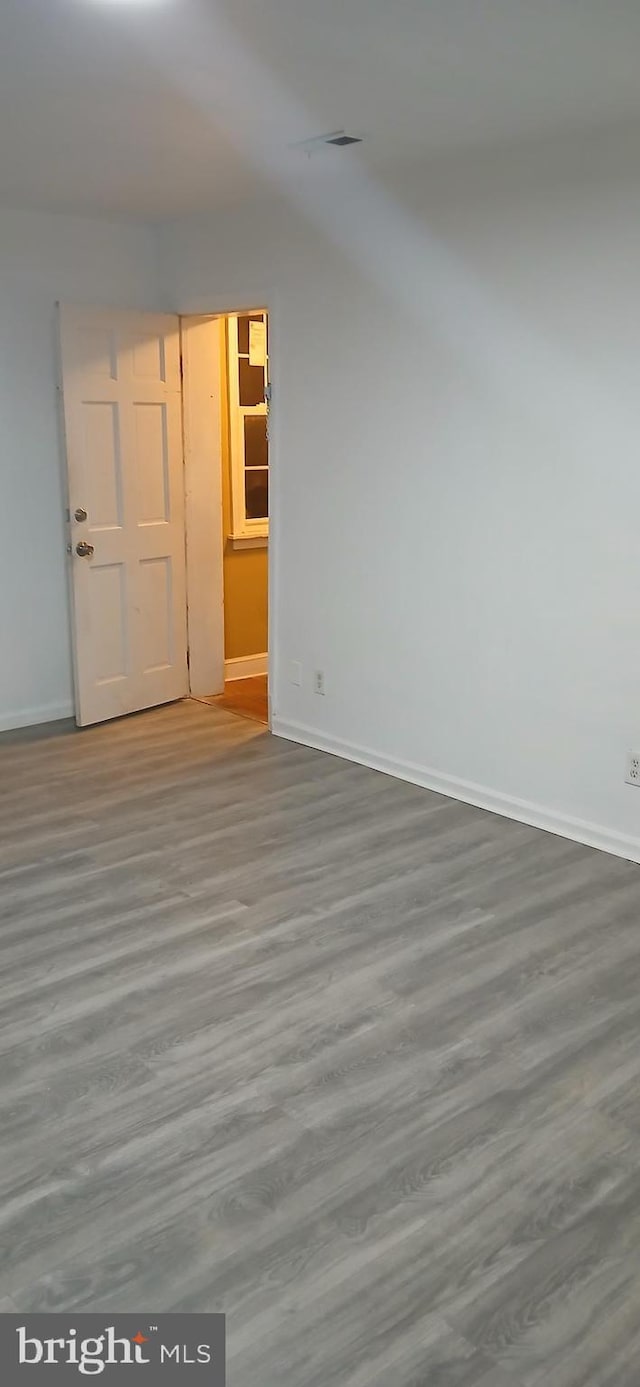 spare room with hardwood / wood-style flooring