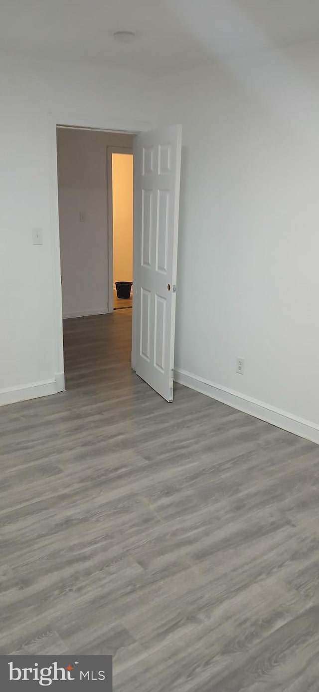 unfurnished room with wood-type flooring