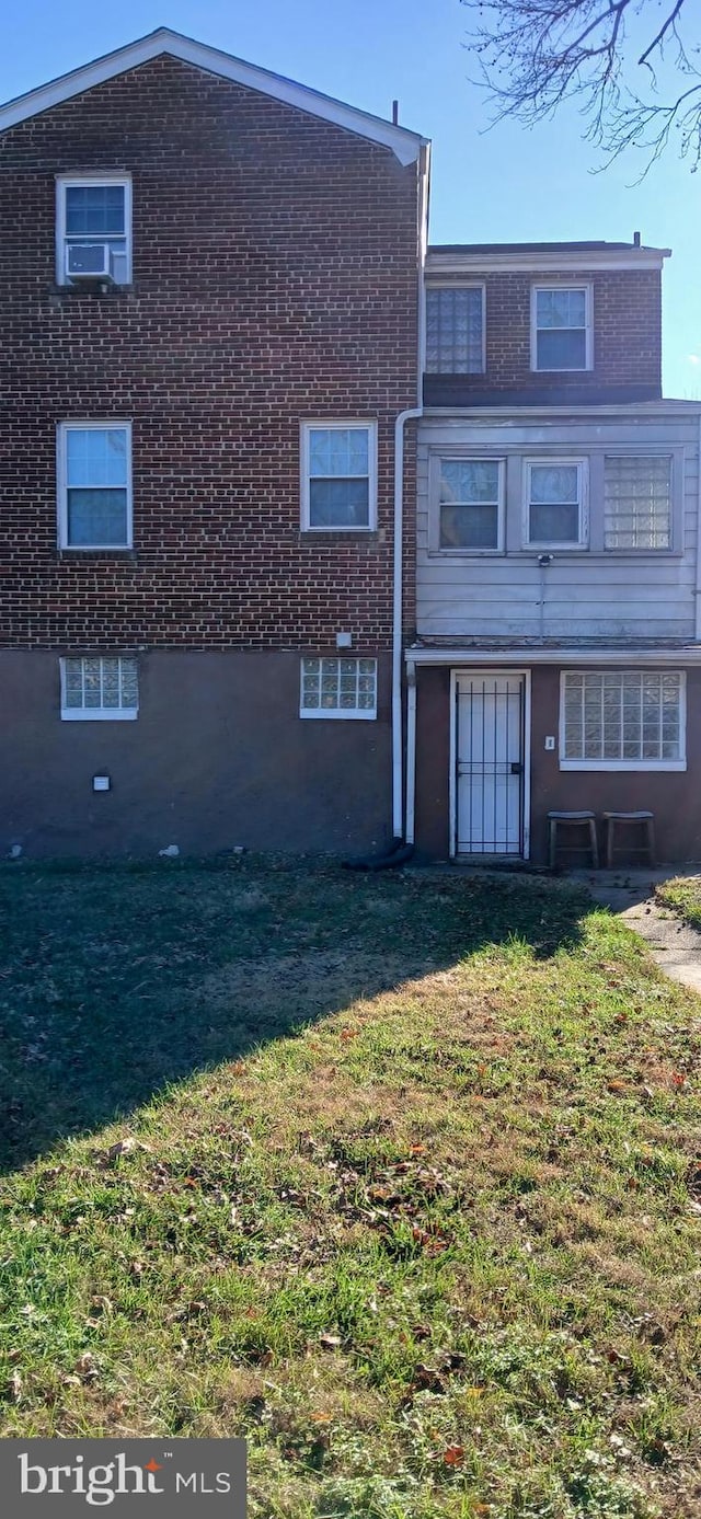 rear view of property with a lawn