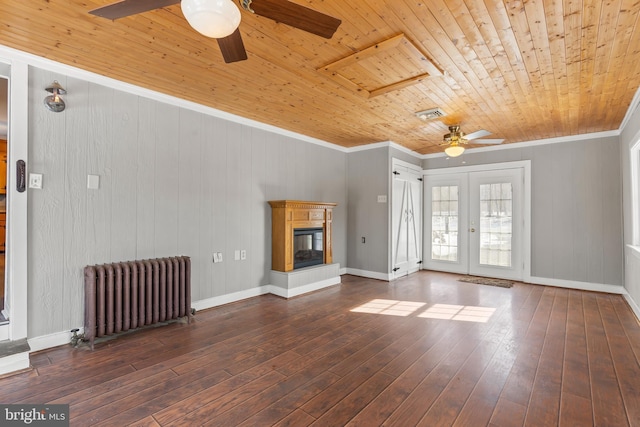 unfurnished living room featuring wooden ceiling, hardwood / wood-style flooring, french doors, radiator, and a glass covered fireplace