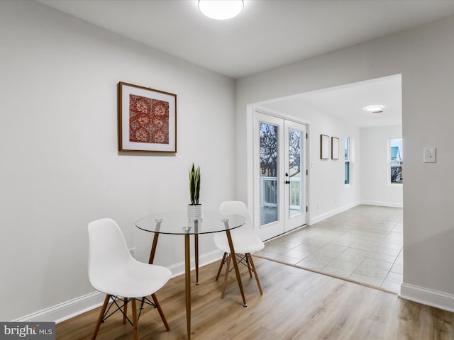 dining area featuring french doors and light hardwood / wood-style floors