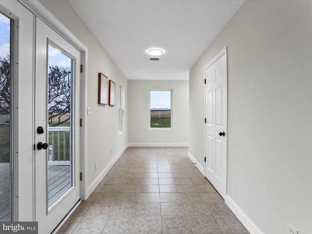 entryway with light tile patterned floors